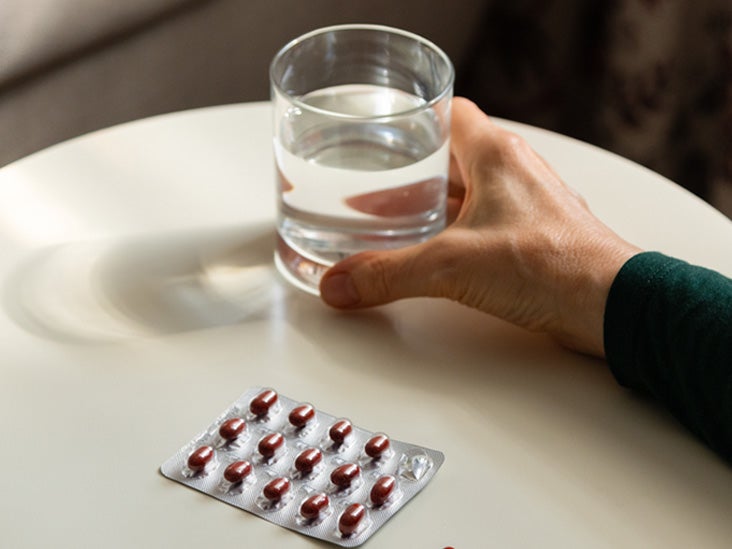 Medication and a glass of water on a table